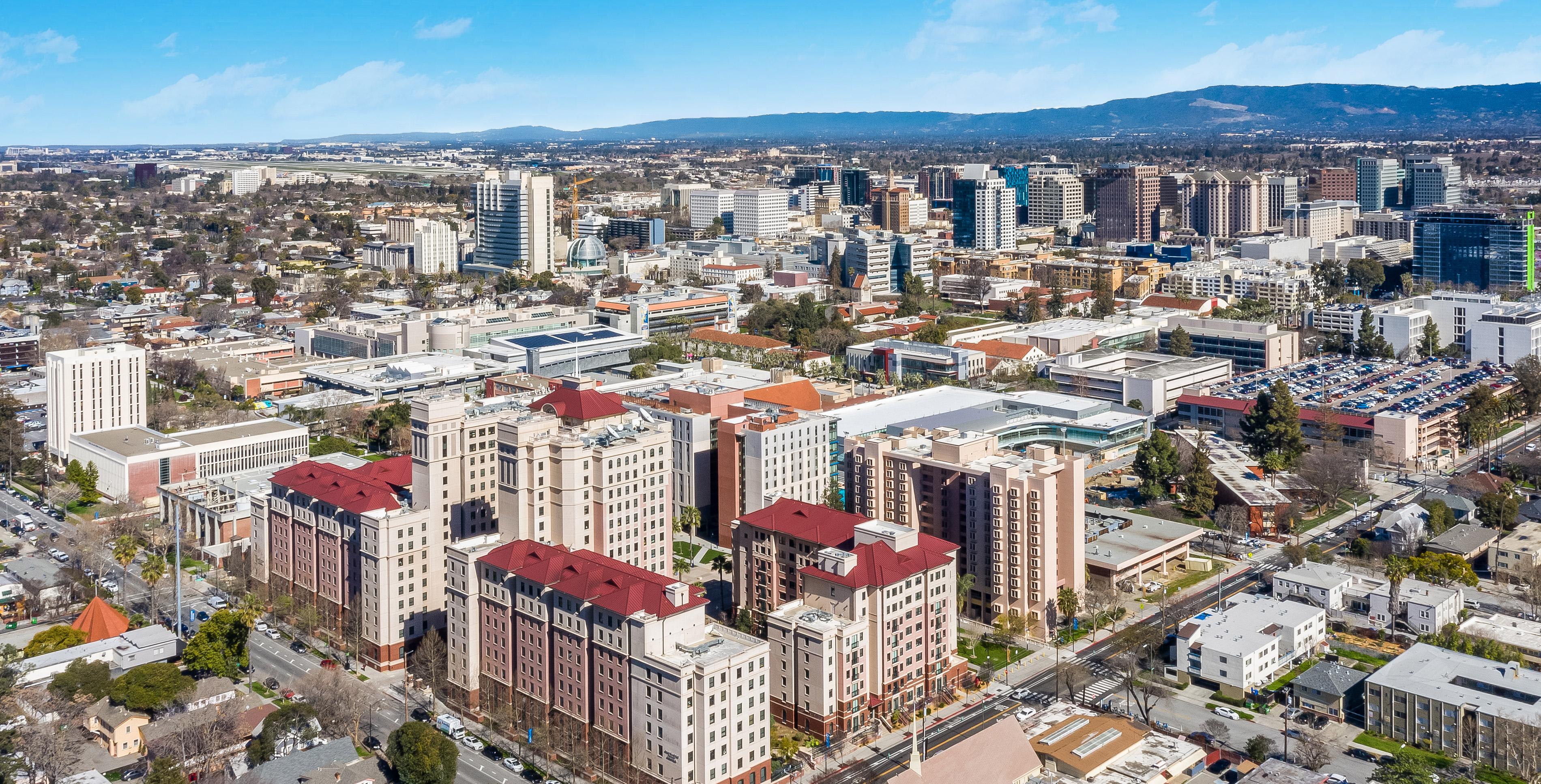 An aerial view of campus, looking northwest towards the dorms and mountains beyond.